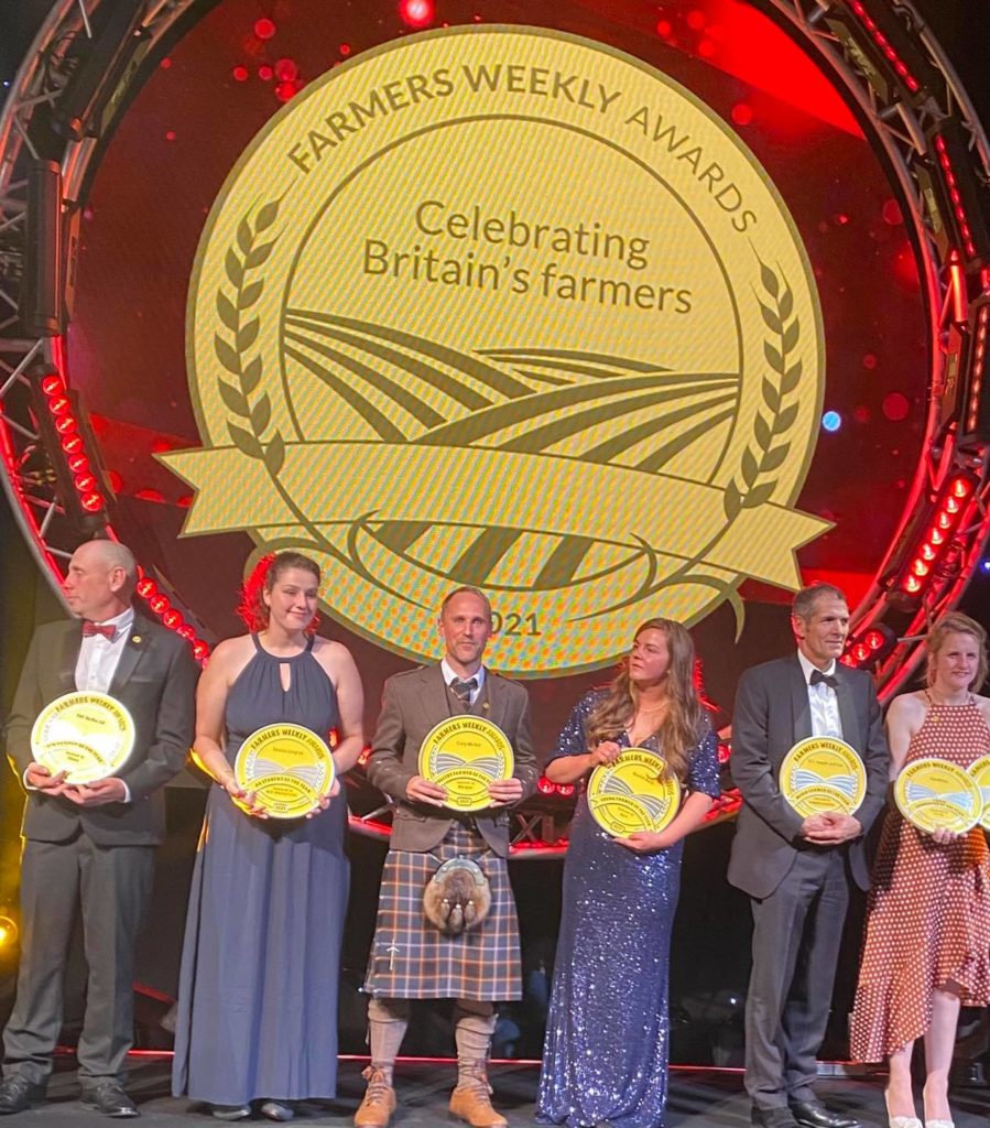 craig-poultry-farmer-of-the-year-awards-2021 Group of award recipients holding plaques at the Farmers Weekly Awards event.